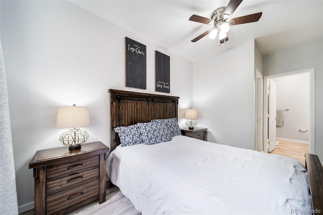 bedroom with vaulted ceiling, ensuite bathroom, light wood-type flooring, and ceiling fan