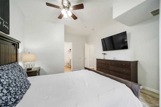 bedroom with ensuite bath, light wood-type flooring, and ceiling fan