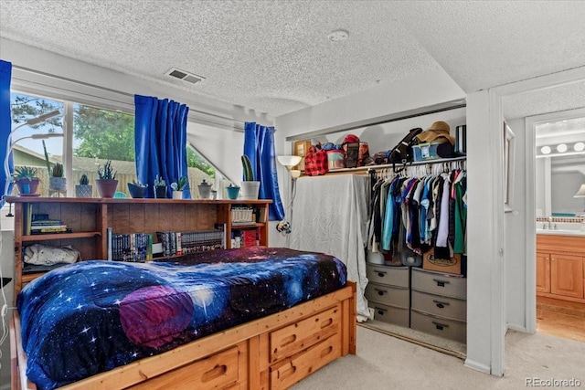 4194 S Kalispell St, Aurora, CO 80013 - carpeted bedroom with a textured ceiling and a closet
