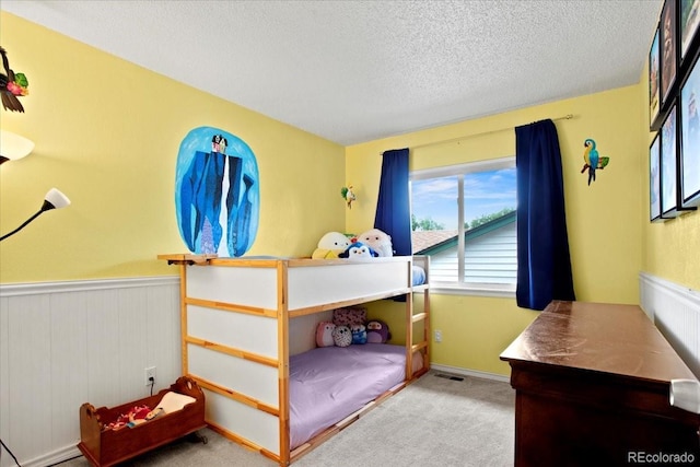 4194 S Kalispell St, Aurora, CO 80013 - carpeted bedroom featuring wainscoting and a textured ceiling
