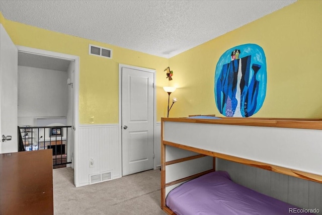 4194 S Kalispell St, Aurora, CO 80013 - bedroom with carpet flooring, a textured ceiling, and a wainscoted wall