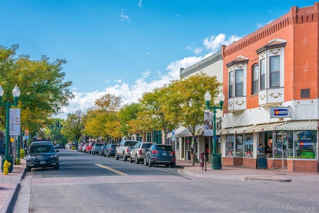5465 Zephyr St Unit 201, Arvada, CO 80002 - view of asphalt street featuring street lighting, sidewalks, curbs, and traffic signs