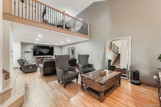 9559 Elizabeth Ct, Thornton, CO 80229 - living room with stairs, a towering ceiling, and light wood-style flooring