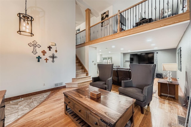 9559 Elizabeth Ct, Thornton, CO 80229 - living area with stairs, light wood-style floors, and a high ceiling