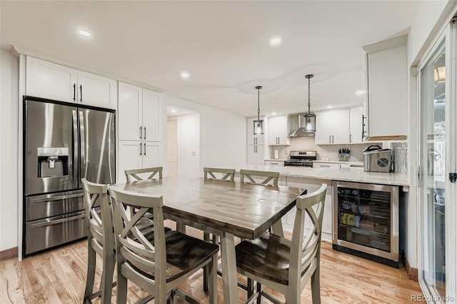 9559 Elizabeth Ct, Thornton, CO 80229 - dining area with wine cooler, light wood-style floors, and recessed lighting