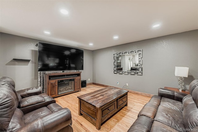 9559 Elizabeth Ct, Thornton, CO 80229 - living room with light wood-style floors, recessed lighting, and a glass covered fireplace