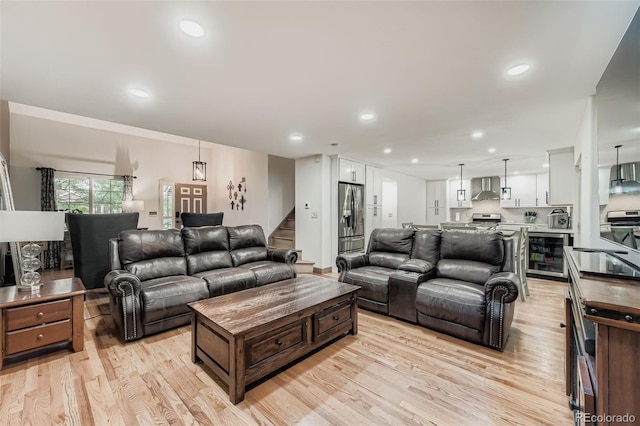 9559 Elizabeth Ct, Thornton, CO 80229 - living room with beverage cooler, light wood finished floors, stairway, and recessed lighting