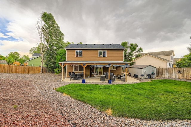 9559 Elizabeth Ct, Thornton, CO 80229 - back of property featuring an outdoor hangout area, a storage unit, a fenced backyard, and a patio area