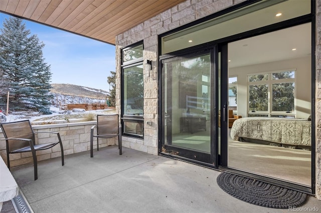 snow covered patio featuring a mountain view