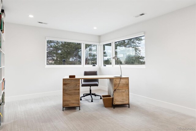 home office with light carpet, baseboards, and visible vents