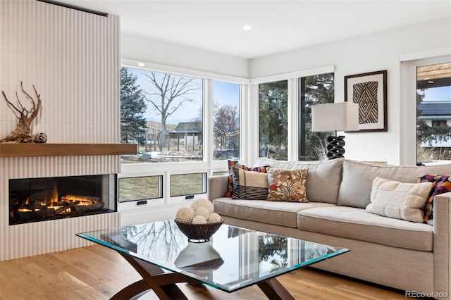 sunroom / solarium with a glass covered fireplace and a healthy amount of sunlight