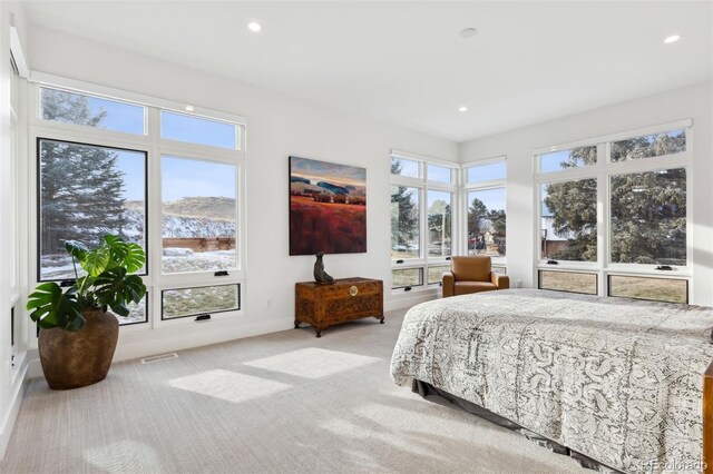 bedroom featuring light carpet, multiple windows, visible vents, and recessed lighting