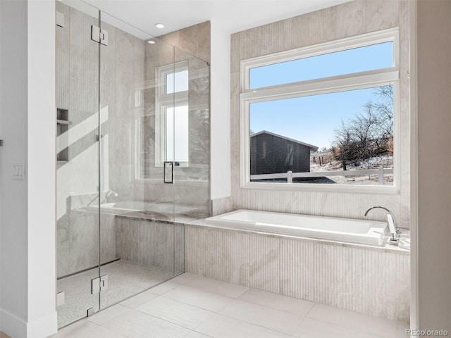 bathroom with a stall shower and a bath