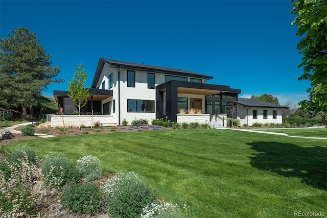 17326 W 57th Ave, Golden, CO 80403 - view of front of house with a front yard and stucco siding