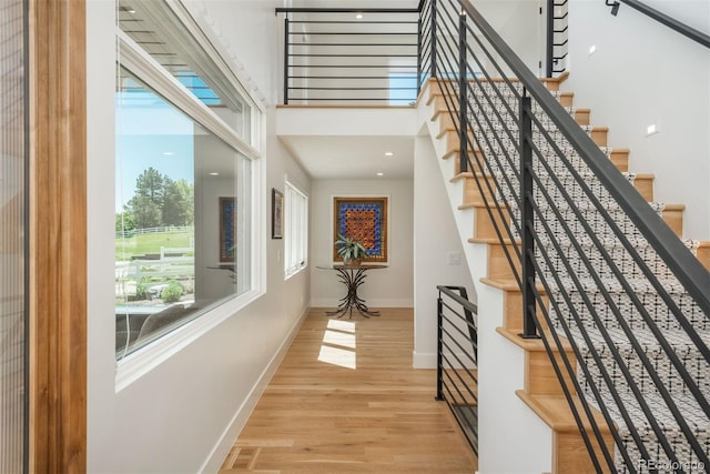 17326 W 57th Ave, Golden, CO 80403 - staircase with wood finished floors, baseboards, and a high ceiling