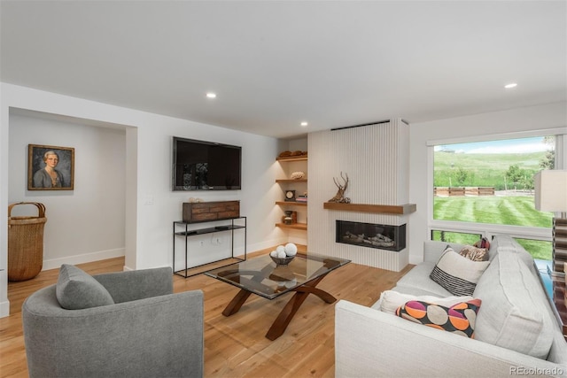 17326 W 57th Ave, Golden, CO 80403 - living room with light wood-style floors, a large fireplace, baseboards, and recessed lighting