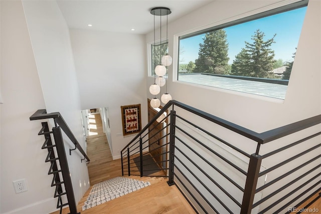 17326 W 57th Ave, Golden, CO 80403 - stairway featuring healthy amount of natural light, wood finished floors, recessed lighting, and baseboards