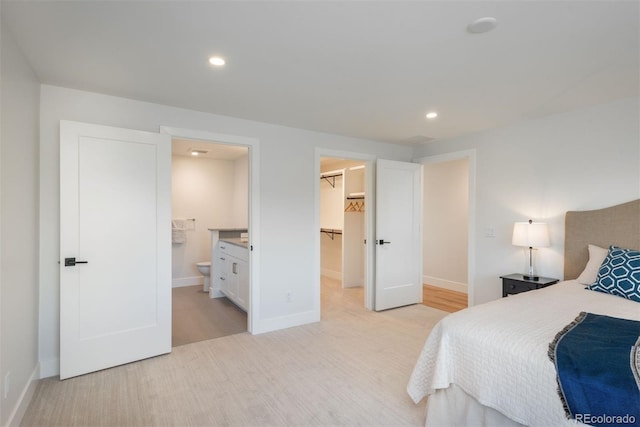 17326 W 57th Ave, Golden, CO 80403 - bedroom featuring a walk in closet, baseboards, light wood-type flooring, and recessed lighting