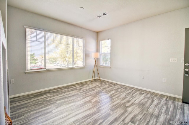 unfurnished room with wood-type flooring