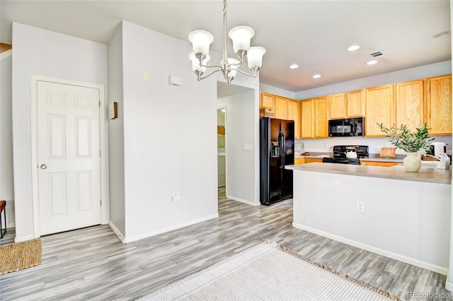 kitchen with pendant lighting, light hardwood / wood-style flooring, light brown cabinets, and black appliances