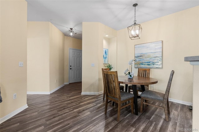 dining space with baseboards, dark wood-type flooring, and a chandelier