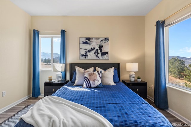 bedroom featuring baseboards and wood finished floors