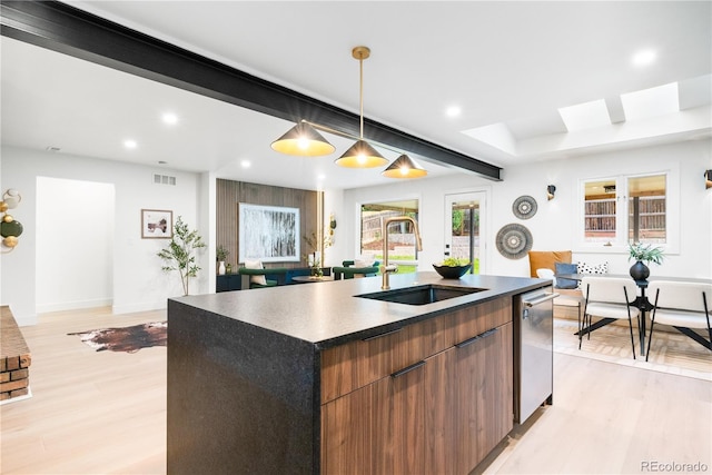 11010 W 29th Ave, Lakewood, CO 80215 - kitchen with dark countertops, recessed lighting, light wood-style flooring, an island with sink, and modern cabinets