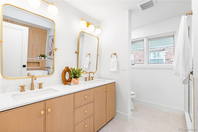 11010 W 29th Ave, Lakewood, CO 80215 - bathroom with double vanity, tile patterned flooring, and a tub to relax in