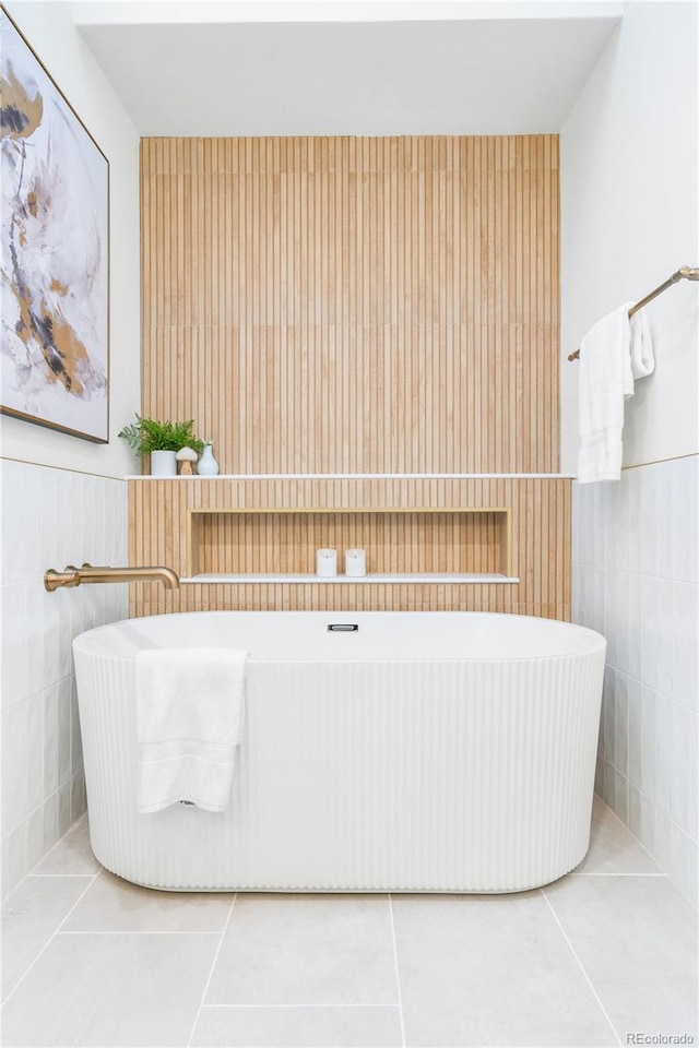 11010 W 29th Ave, Lakewood, CO 80215 - full bath featuring tile patterned flooring, a freestanding tub, tile walls, and a wainscoted wall