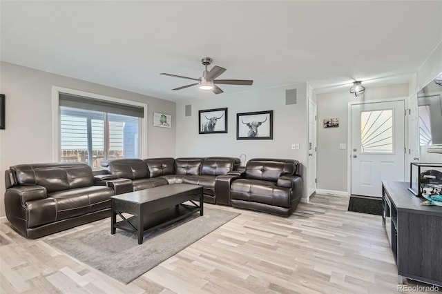 living room with light wood-type flooring and ceiling fan