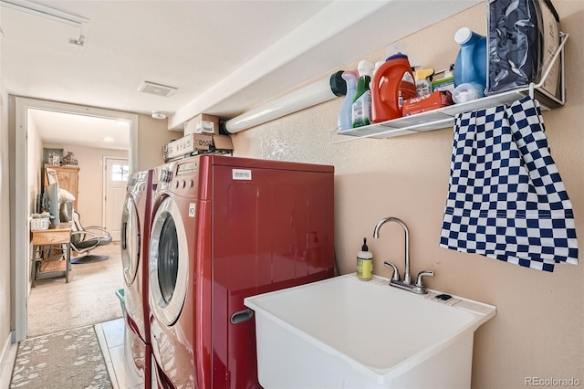 washroom with washer and clothes dryer and sink