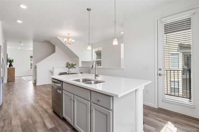 2140 Santini Trl Unit F, Littleton, CO 80129 - kitchen with a sink, stainless steel dishwasher, gray cabinetry, a chandelier, and wood finished floors