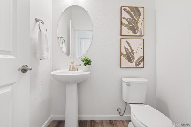 2140 Santini Trl Unit F, Littleton, CO 80129 - bathroom featuring toilet, wood finished floors, and baseboards