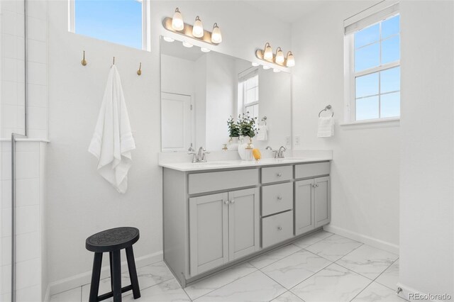 2140 Santini Trl Unit F, Littleton, CO 80129 - full bathroom featuring marble look tiles, double vanity, and baseboards