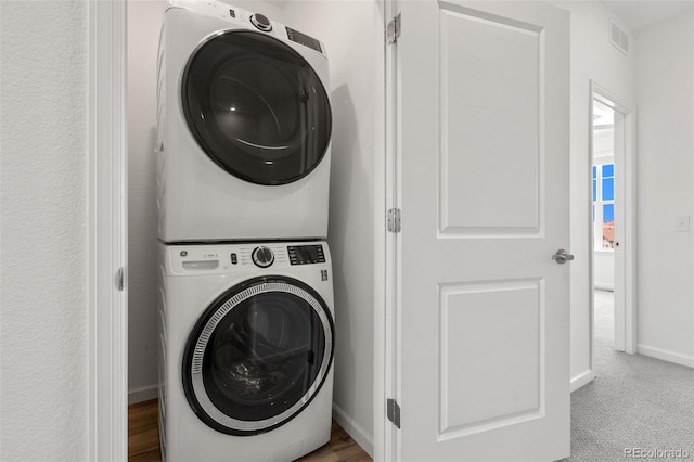 2140 Santini Trl Unit F, Littleton, CO 80129 - washroom with estacked washer and dryer and baseboards