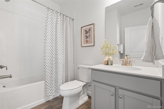 2140 Santini Trl Unit F, Littleton, CO 80129 - full bath with wood finished floors, toilet, vanity, and shower / bathtub combination with curtain