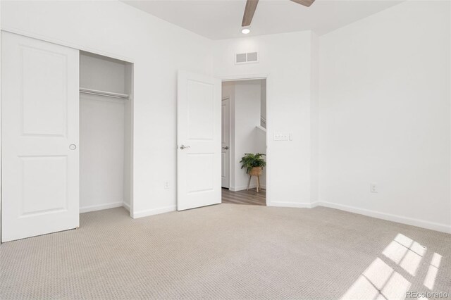 2140 Santini Trl Unit F, Littleton, CO 80129 - unfurnished bedroom featuring light colored carpet, a closet, baseboards, and a ceiling fan