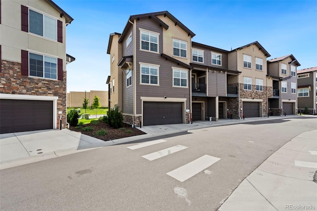 2140 Santini Trl Unit F, Littleton, CO 80129 - townhome / multi-family property with stone siding, an attached garage, and a residential view