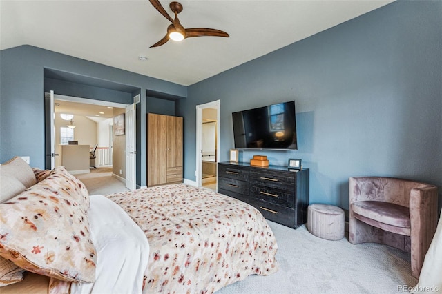 bedroom featuring light carpet, lofted ceiling, a ceiling fan, and baseboards