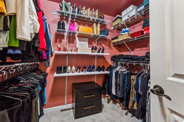 walk in closet featuring carpet