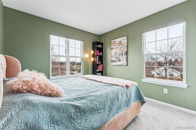 bedroom with carpet and baseboards