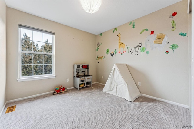 playroom featuring carpet floors, baseboards, visible vents, and a wealth of natural light