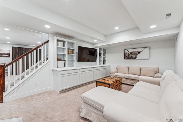 living area with stairs, visible vents, light colored carpet, and recessed lighting