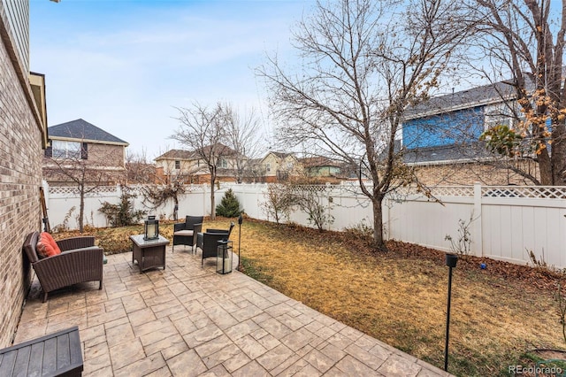 view of patio / terrace featuring a water view and a fenced backyard