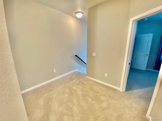 spare room featuring light colored carpet