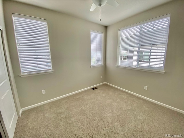 empty room featuring ceiling fan and carpet floors