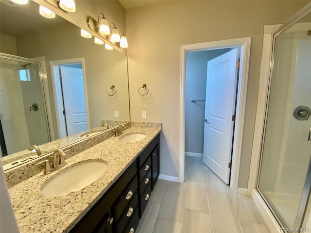 bathroom with tile patterned floors, vanity, and an enclosed shower