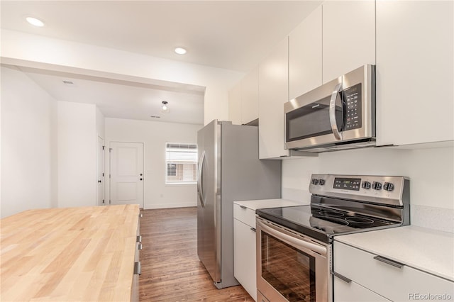 kitchen featuring stainless steel appliances, light wood-type flooring, and white cabinets