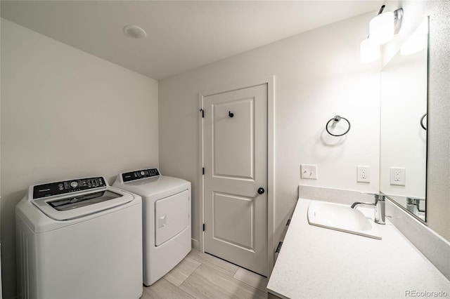 washroom with sink and independent washer and dryer