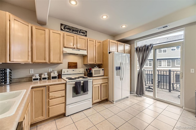 kitchen featuring light brown cabinetry, light countertops, under cabinet range hood, recessed lighting, and white appliances